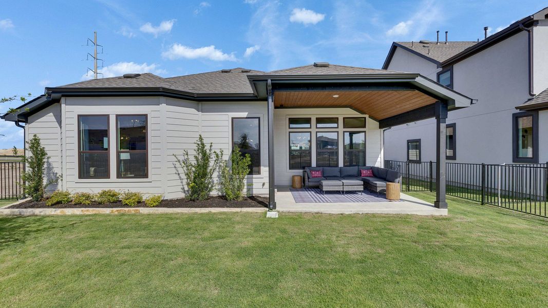 Elegant covered patio features premium seating and large windows in Lakeside Meadows. Fenced for privacy. Elegant covered patio features premium seating and large windows in Lakeside Meadows. Fenced for privacy.