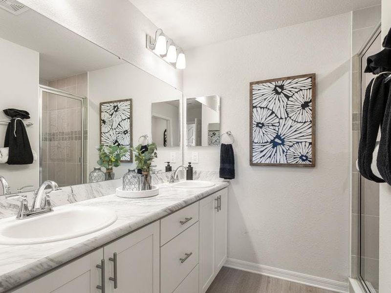 Your suite is complete with a walk-in wardrobe and spacious en-suite bath - Flora townhome by Highland Homes