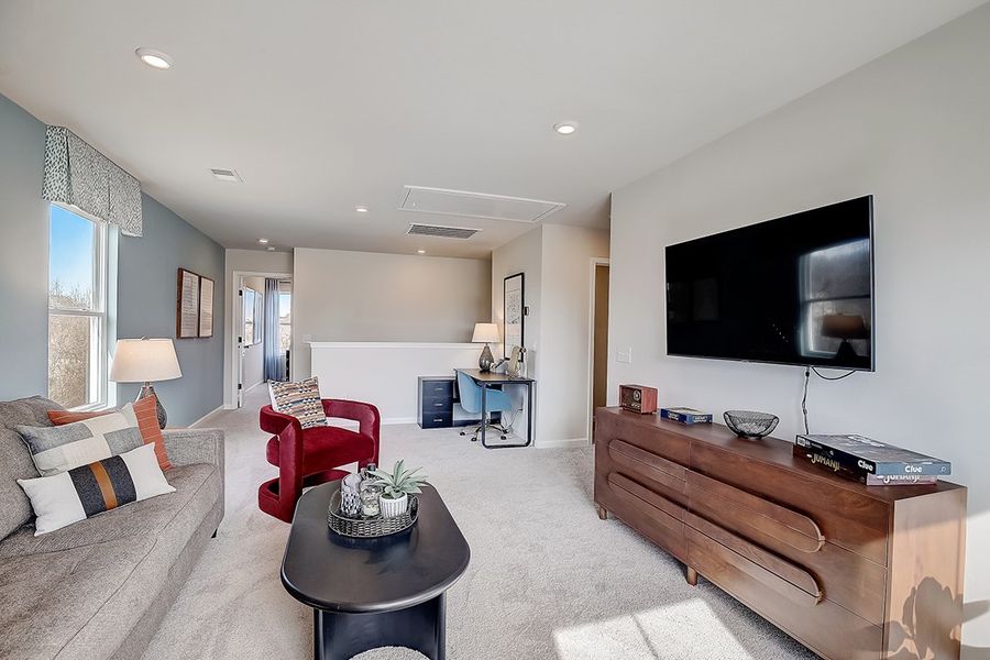 A living room with a tv and couches. A living room with a tv and couches.