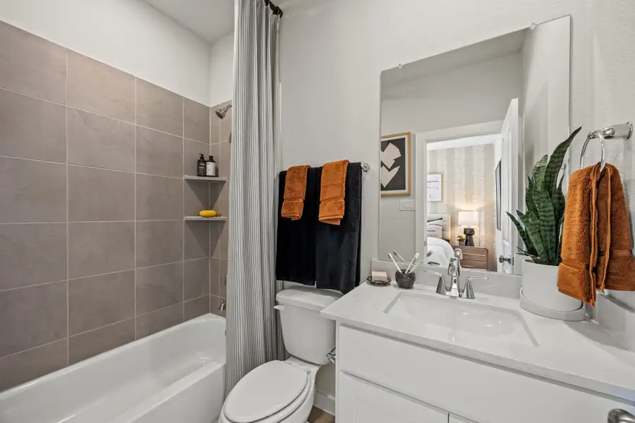 A bathroom with a tub toilet and sink.