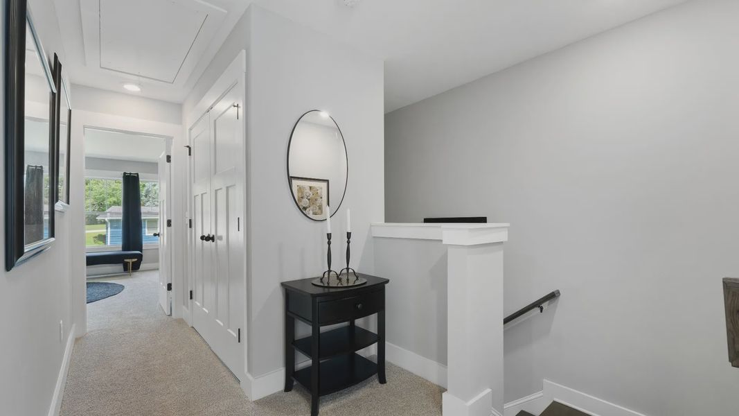 Carpeted hallway with elevated ceilings in two story townhome at Tyger Ridge by DRB Homes in Spartanburg, SC Carpeted hallway with elevated ceilings in two story townhome at Tyger Ridge by DRB Homes in Spartanburg, SC