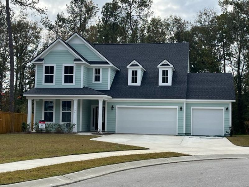 A charming blue two-story home with a spacious yard in Enclave at South Pointe Estates by DRB Homes (Summerville, SC).