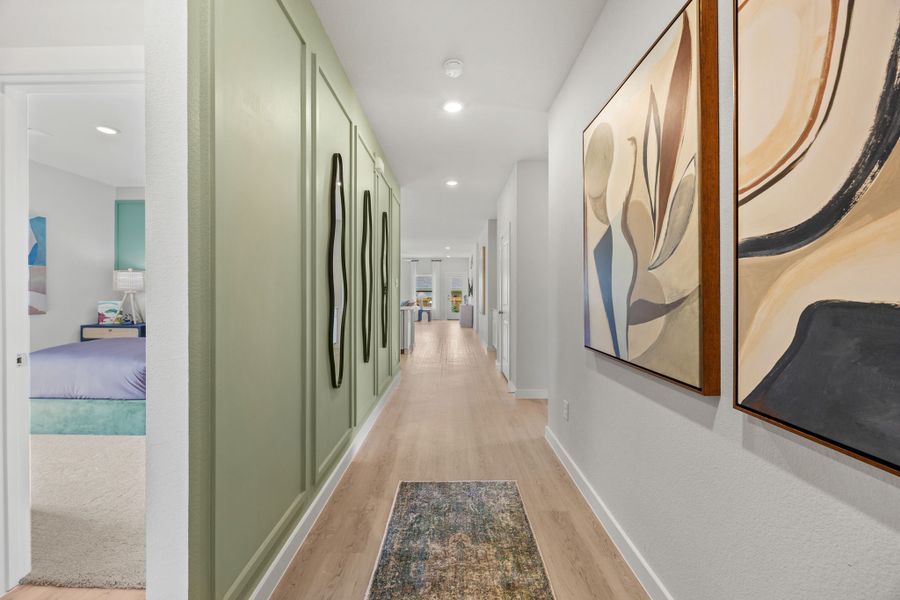 A hallway with a bed and a rug. A hallway with a bed and a rug.