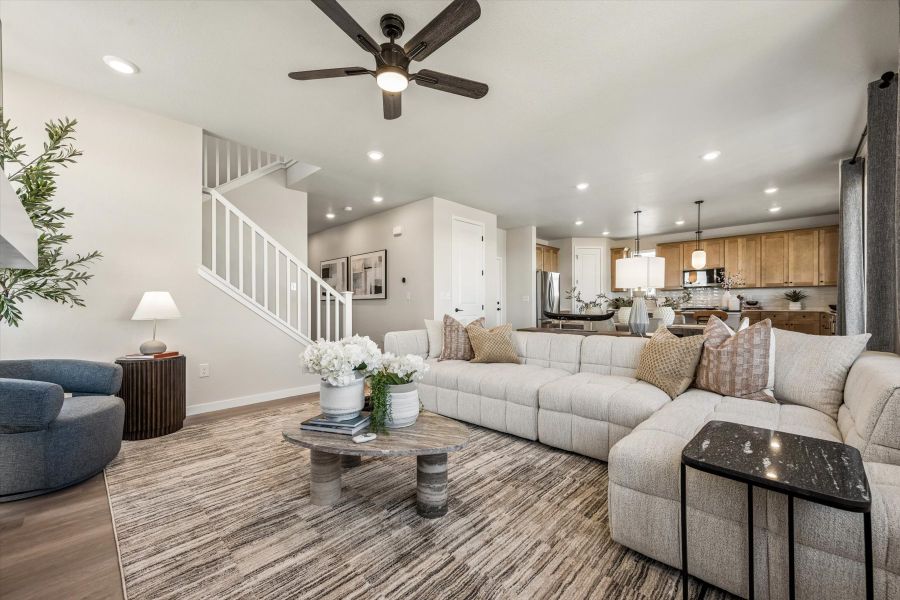 A large living room with a large chandelier and a large couch. A large living room with a large chandelier and a large couch.