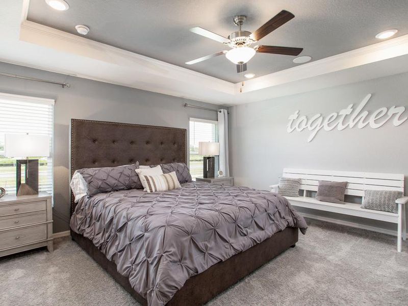 Relax in your spacious owner`s suite with an elegant tray ceiling - Serendipity model home in Winter Haven