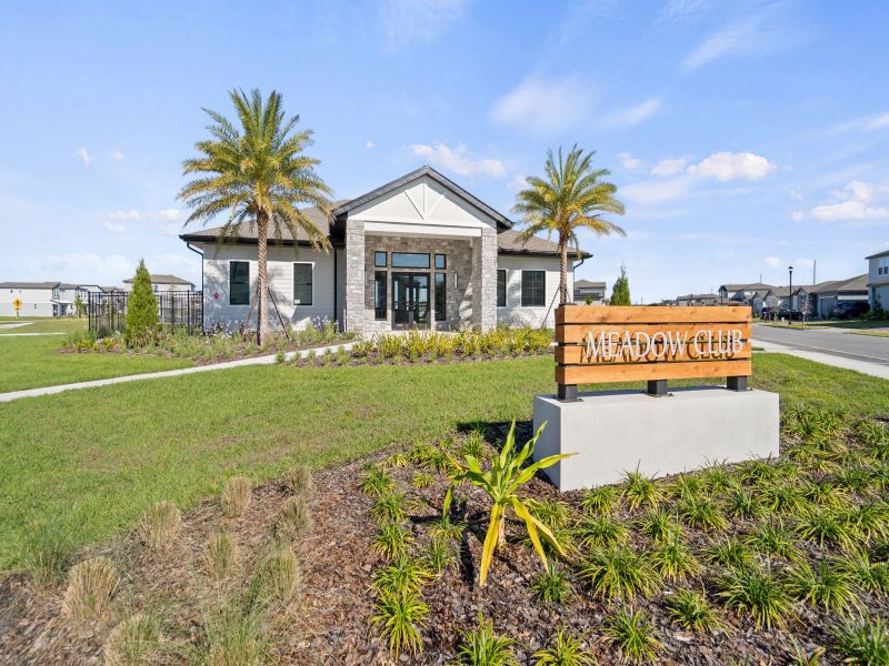 Entrance to the The Meadow at Crossprairie Bungalows community in St. Cloud, FL, featuring signage and landscaping (Image 2).