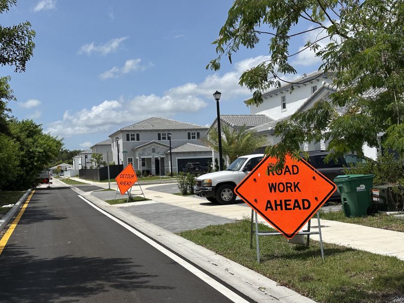 Beautiful modern homes on a sunny day, amidst road work in Salerno by Lennar in Richmond West, FL.