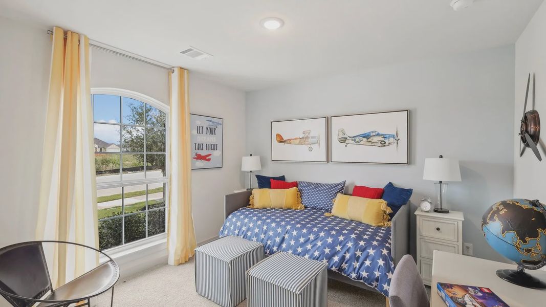 Elegant arched window and vibrant aviation themes highlight this Still Water Lake Estates bedroom.