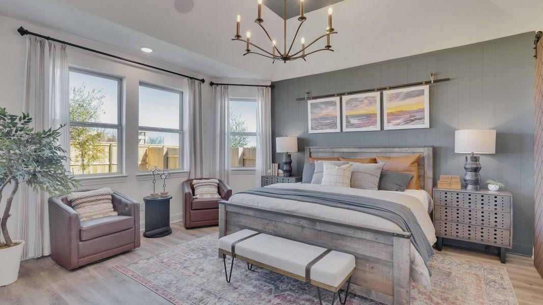 Briarwood bedroom showcases vaulted ceiling, refined chandelier, and plush design. A blend of luxury and comfort.