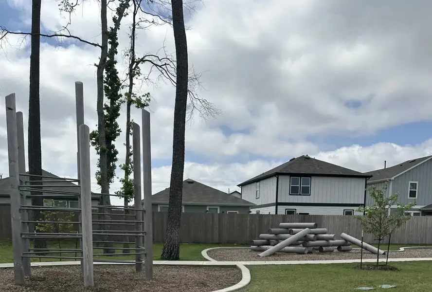 Charming homes with a community park in Peppervine by Centex in Porter, TX, featuring modern play structures.