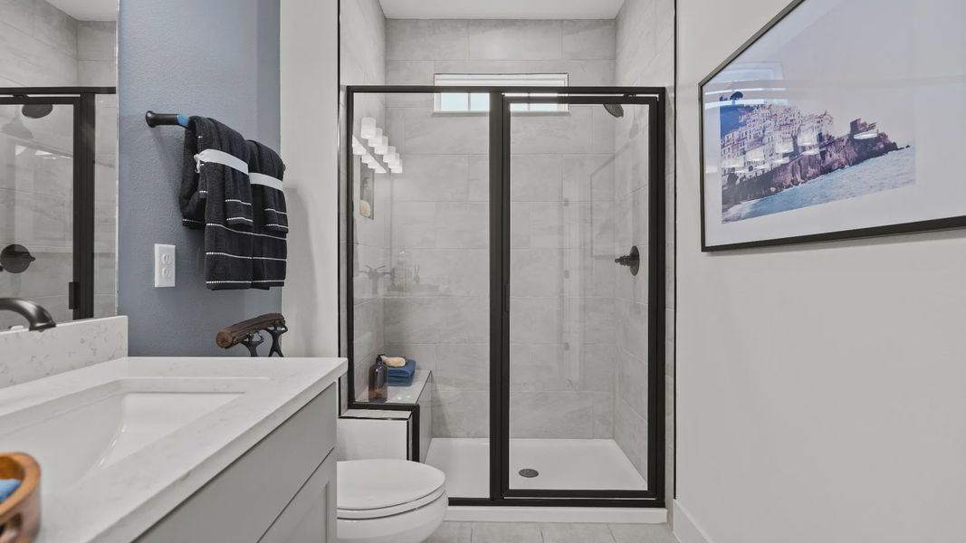 The primary suite bathroom at Parkview at Hamlin by DRB Homes offers a spa-like retreat with dual sinks and a walk-in shower