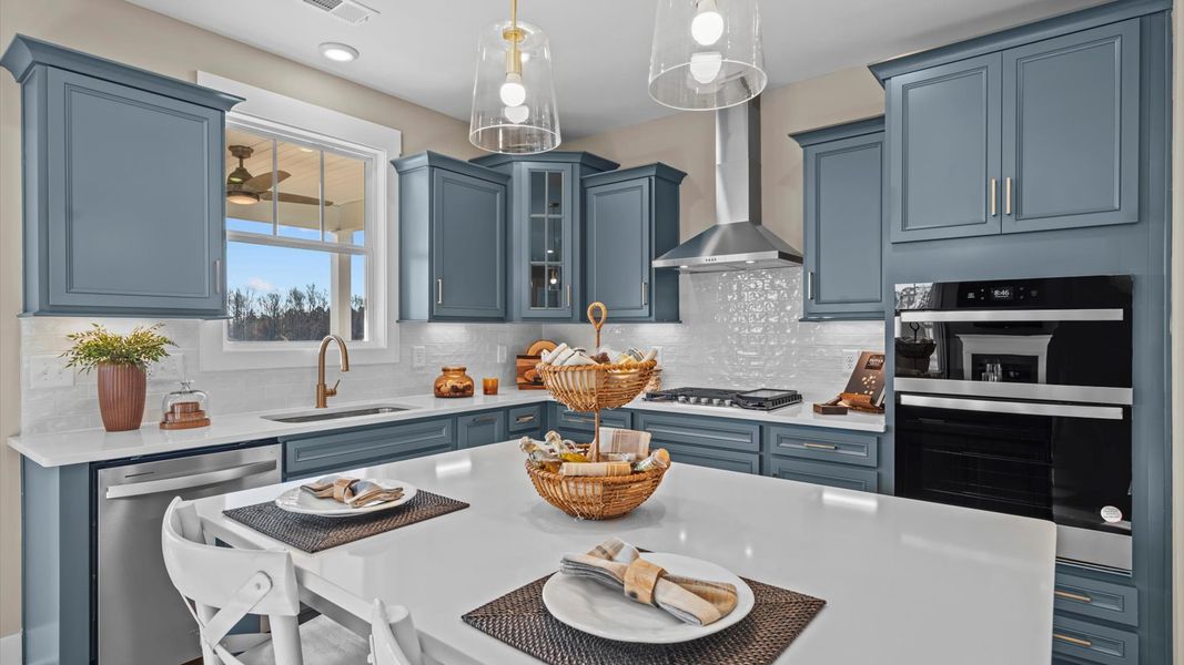 Exceptional kitchen featuring a spacious island, eye-catching pendant lights, and modern finishes in Spartanburg, SC