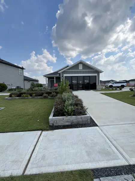 A charming single-story home with a spacious driveway and lush landscaping in Redbud 40s by Taylor Morrison (Hockley, TX). A charming single-story home with a spacious driveway and lush landscaping in Redbud 40s by Taylor Morrison (Hockley, TX).