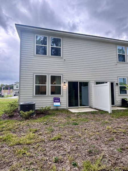 A modern two-story home with light siding in The Villas at Bishop Oaks by Century Communities (Jacksonville, FL).