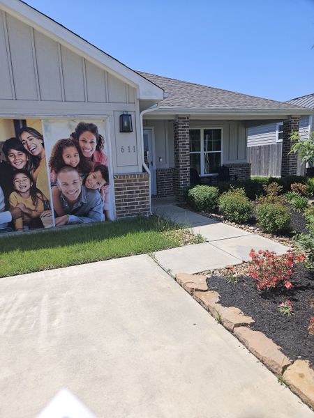 A charming home with a welcoming garden path in Santa Fe by Home Creations (Cleveland, TX).