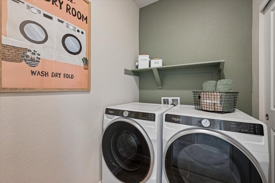 A laundry room with a washer and dryer. A laundry room with a washer and dryer.