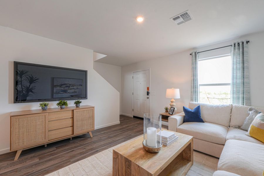 A living room with a couch and a coffee table. A living room with a couch and a coffee table.