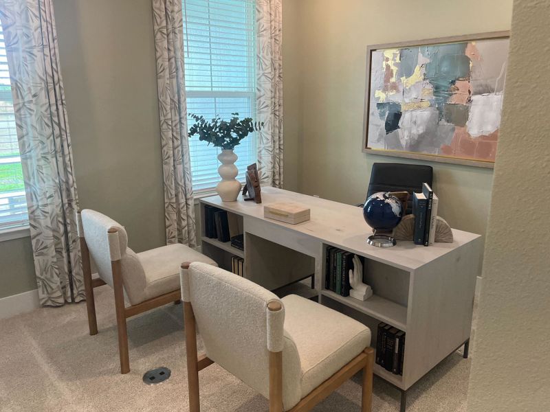A cozy home office with neutral tones, modern desk, stylish chairs, abstract art, and elegant decor. A cozy home office with neutral tones, modern desk, stylish chairs, abstract art, and elegant decor.