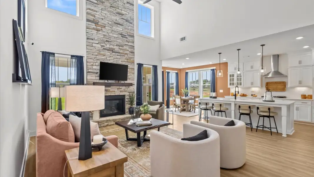 Tasteful family room with two-story volume, refined finishes, and exceptional natural light by DRB Homes