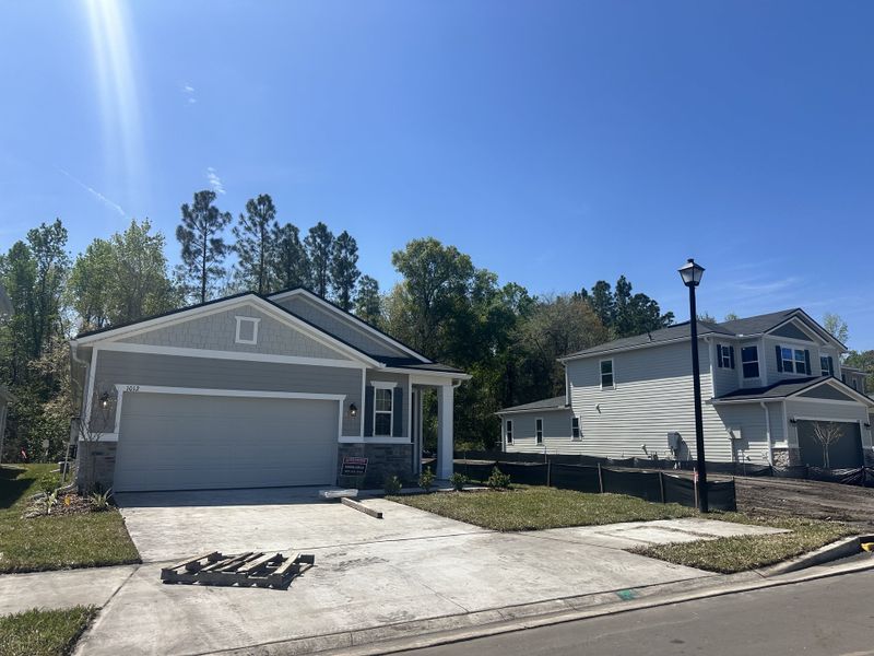 A modern gray home with a two-car garage in Seasons at Marietta Cove by Richmond American Homes (Jacksonville, FL).
