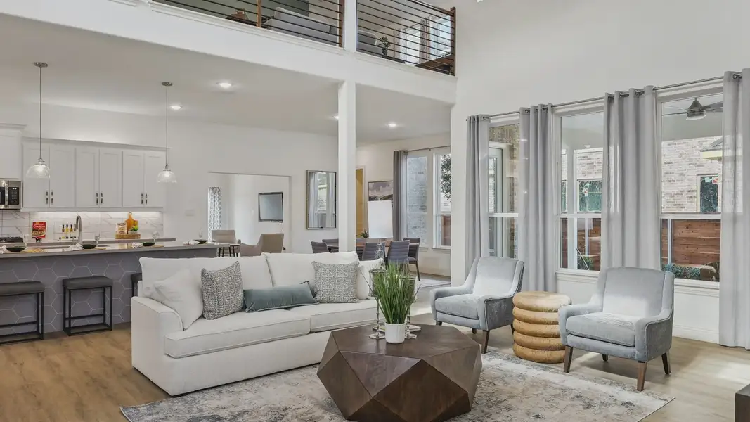 Experience airy elegance in Solterra, Texas. Sleek railing, expansive windows, and premium wood floors elevate style.