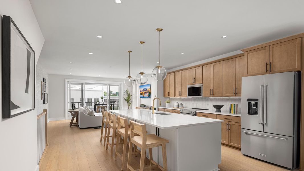 Gourmet kitchen boasts a large center island and stainless steel appliances Gourmet kitchen boasts a large center island and stainless steel appliances