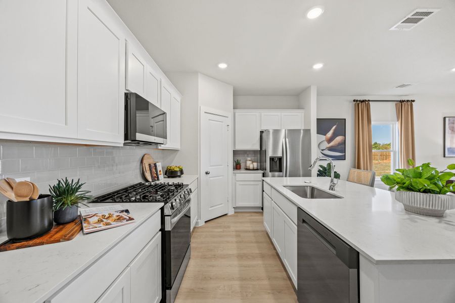 A kitchen with white cabinets.