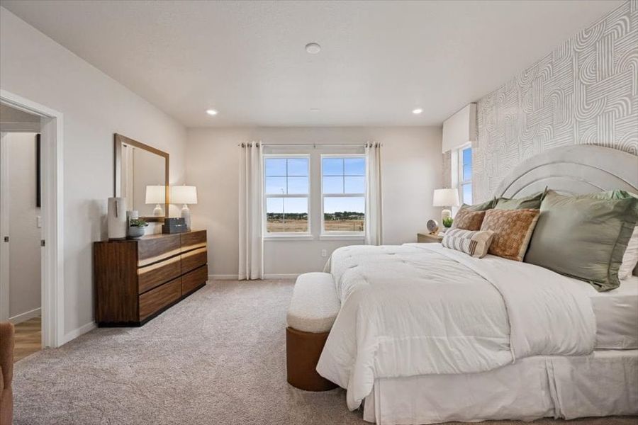 A bedroom with a bed and a desk. A bedroom with a bed and a desk.