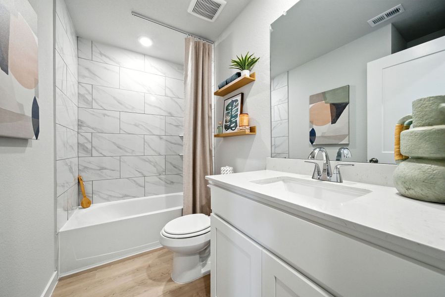 A bathroom with a tub sink and toilet. A bathroom with a tub sink and toilet.