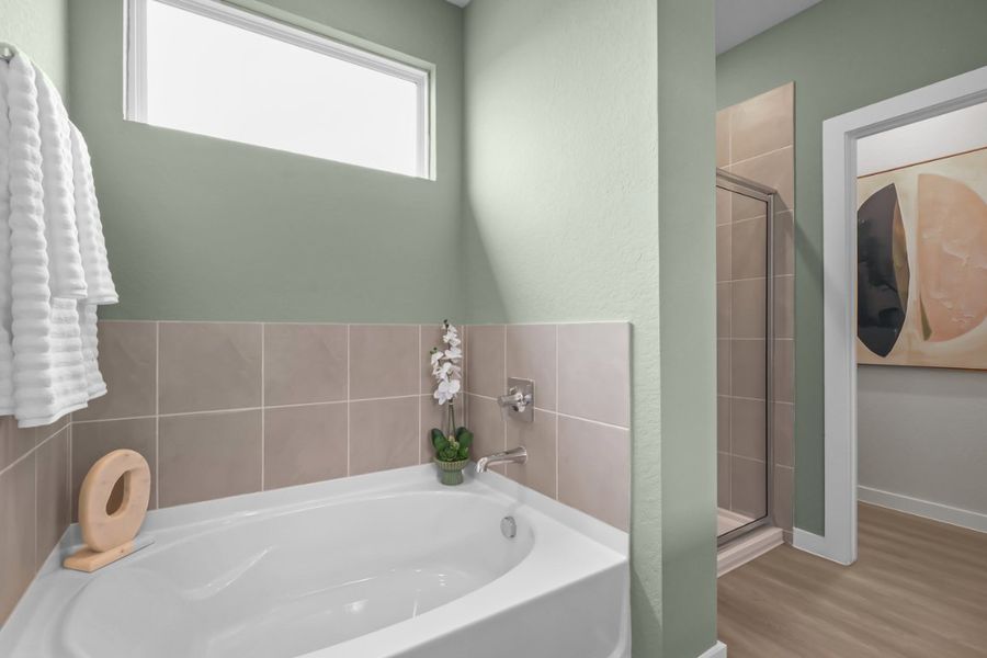 A bathroom with a tub and a toilet. A bathroom with a tub and a toilet.
