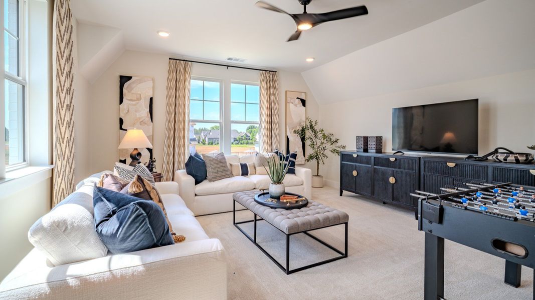 Bonus room with carpet flooring and plenty windows
