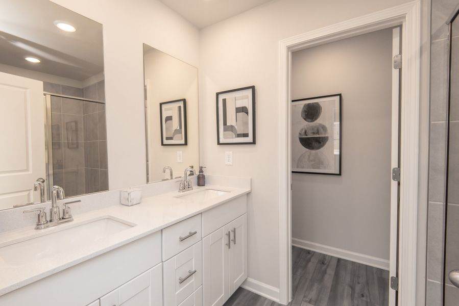 Simplify your mornings with the ease of dual-sinks and abundant counter space in this bathroom.