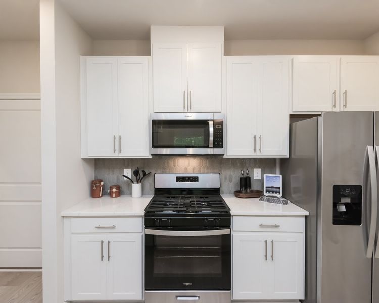 Stylish cabinets and a sleek stovetop add charm and function to your kitchen.