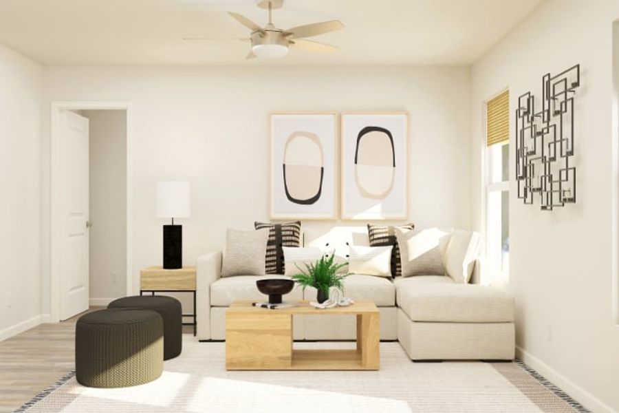 A living room with a white couch and a white ceiling fan. A living room with a white couch and a white ceiling fan.