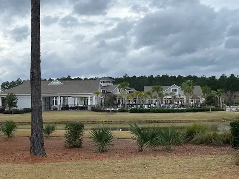 Elegant clubhouse with scenic views and lush landscaping in Four Seasons at Lakes of Cane Bay by K. Hovnanian® Homes (Summerville, SC).