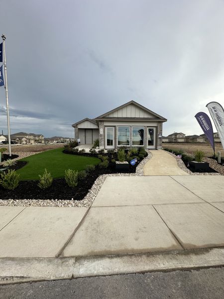 Charming contemporary home with a manicured lawn in Preserve at Medina by D.R. Horton (Von Ormy, TX).