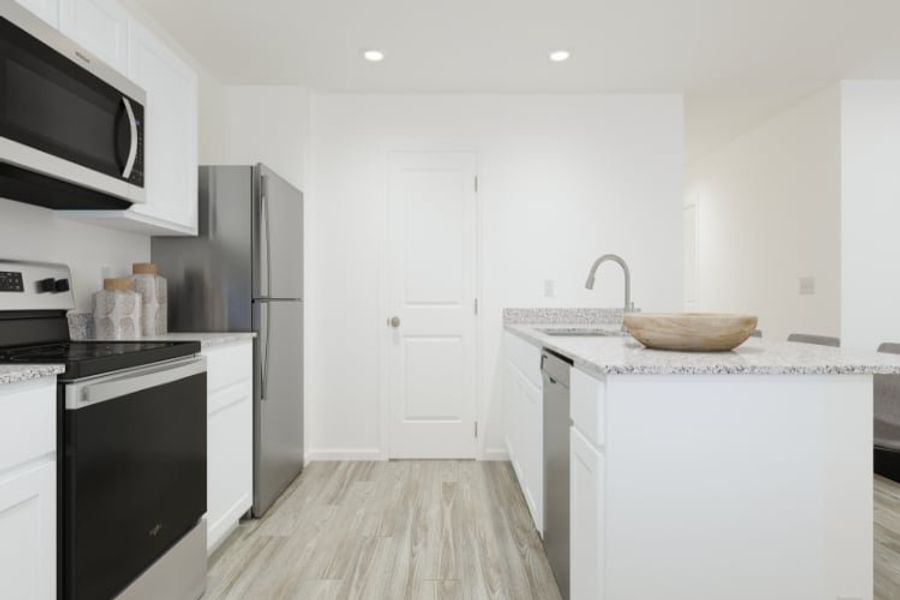 A kitchen with white cabinets. A kitchen with white cabinets.