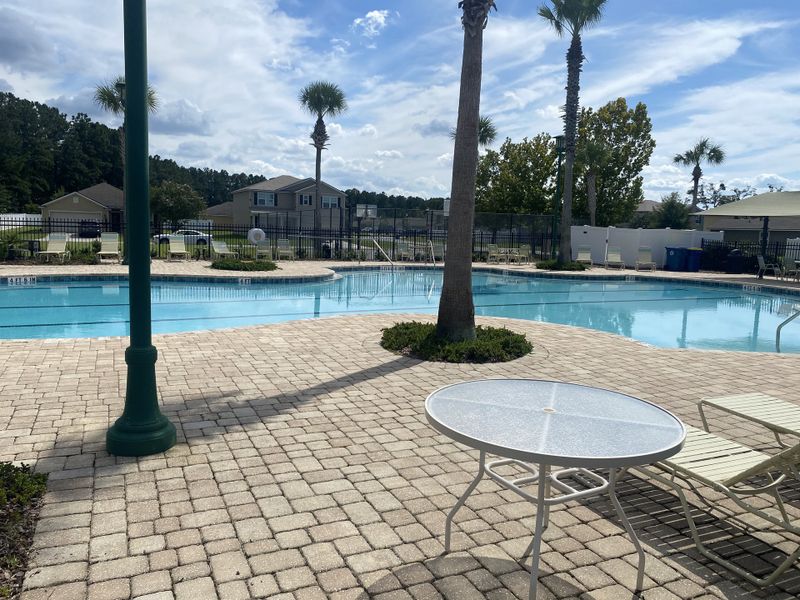 A beautiful community pool with spacious deck in Westport Landing by LGI Homes, offering perfect relaxation in Jacksonville, FL.