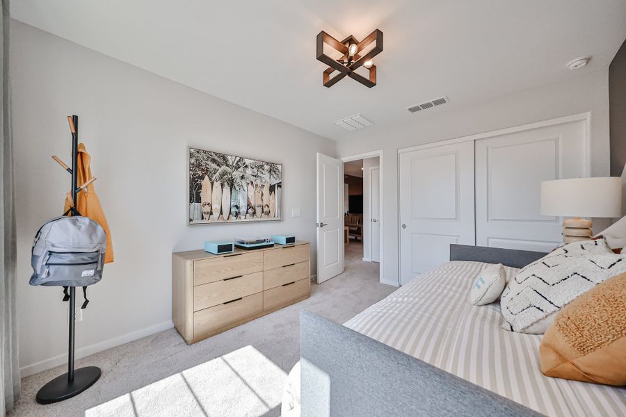 A bedroom with a bed and a lamp.