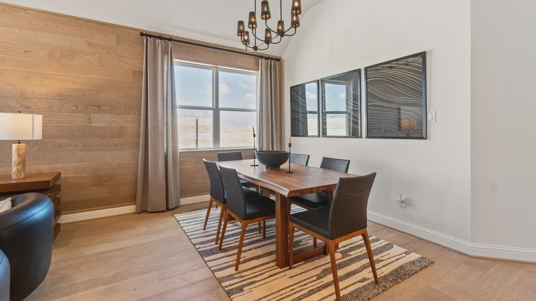 Exquisite accent wall highlights contemporary chandelier and wood finishes in River Ranch.