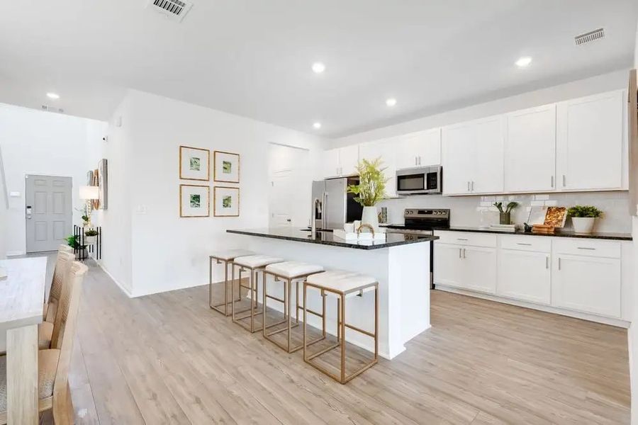 Furnished interior in a model home at Village Grove in Dripping Springs (Image 7).