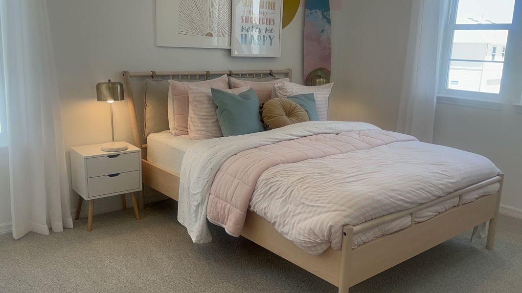 A cozy bedroom featuring a sleek nightstand, soft pastel bedding, and modern decor. A cozy bedroom featuring a sleek nightstand, soft pastel bedding, and modern decor.