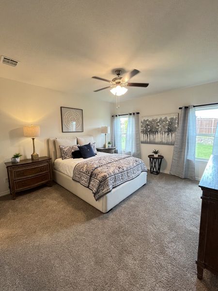 A cozy bedroom with plush carpeting, elegant bedding, warm lighting, and serene wall art, creating a peaceful atmosphere. A cozy bedroom with plush carpeting, elegant bedding, warm lighting, and serene wall art, creating a peaceful atmosphere.