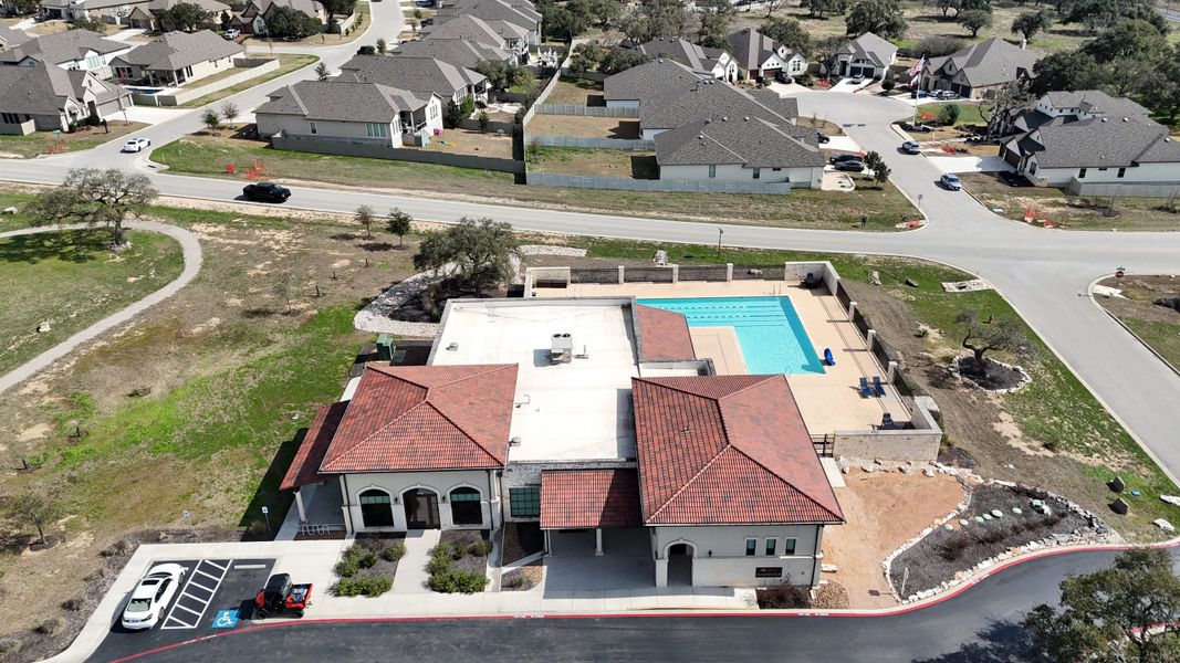 Aerial view of community amenities and homes at The Grove at Vintage Oaks by Scott Felder Homes (New Braunfels, TX).