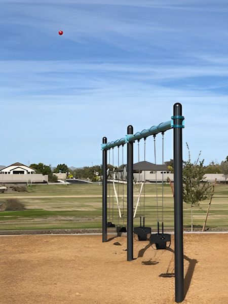 A scenic community playground with swings in Edgewood Estates by K. Hovnanian® Homes, Queen Creek, AZ.