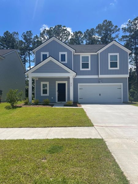 A charming blue two-story home with a spacious garage in Cypress Preserve: American Dream Series by Lennar (Moncks Corner, SC).
