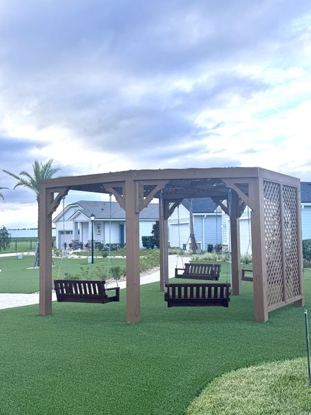 A charming gazebo with wooden swings on lush lawns in Reverie at Silverleaf by Dream Finders Homes (St. Augustine, FL). A charming gazebo with wooden swings on lush lawns in Reverie at Silverleaf by Dream Finders Homes (St. Augustine, FL).