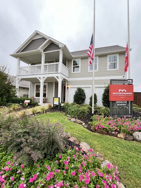 A charming two-story home with a welcoming porch and lush garden in Waterscape 50s Sales Phase 2 by HistoryMaker Homes (Royse City, TX).