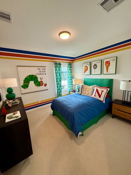 A vibrant children's bedroom with playful striped walls, colorful bedding, and themed artwork for a lively atmosphere.