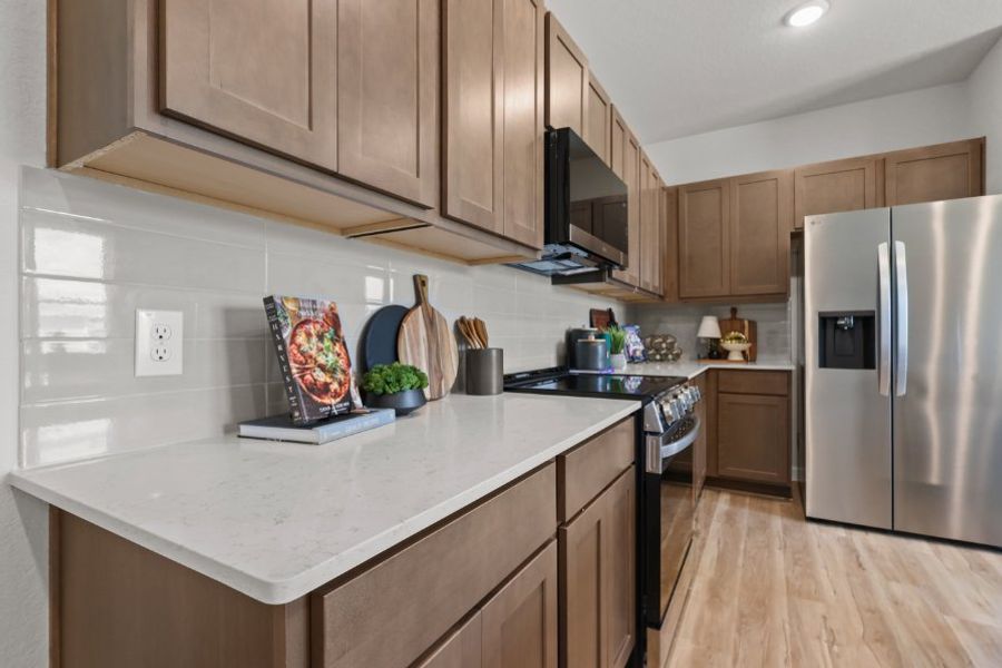 A kitchen with wooden cabinets.